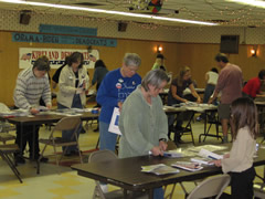 Volunteers stuffing bags with candidate material